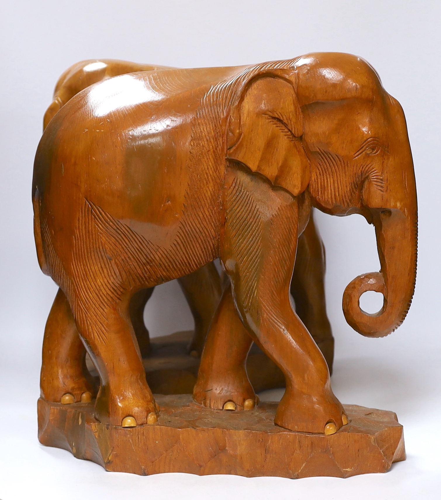 A pair of carved elephants, 42cm high